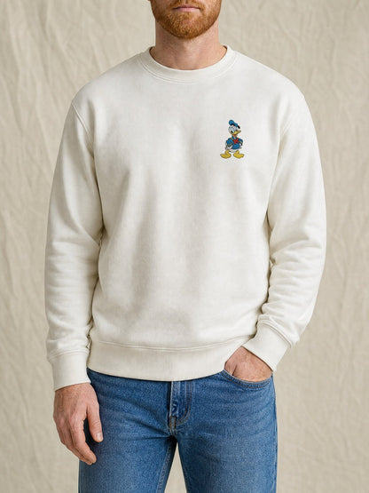 Broderie Donald sur le pull blanc, côté cœur